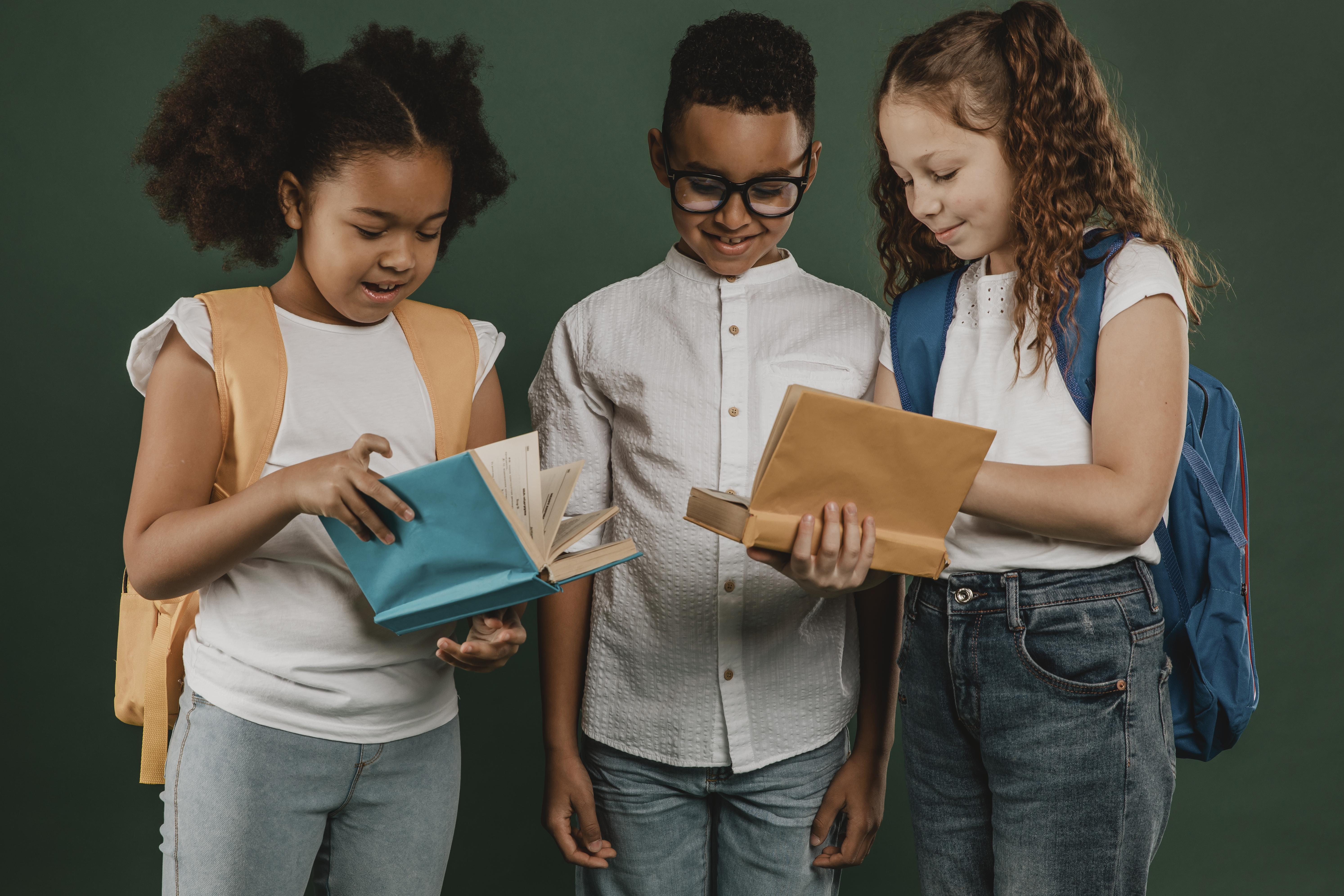 school-colleagues-looking-through-books-together.jpg